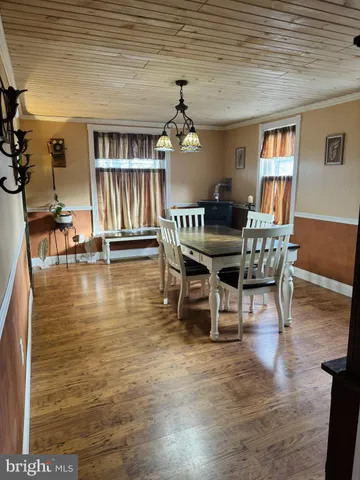 a view of a dining room with furniture wooden floor and chandelier