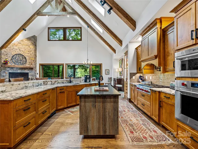 a kitchen with stainless steel appliances granite countertop a sink and a stove
