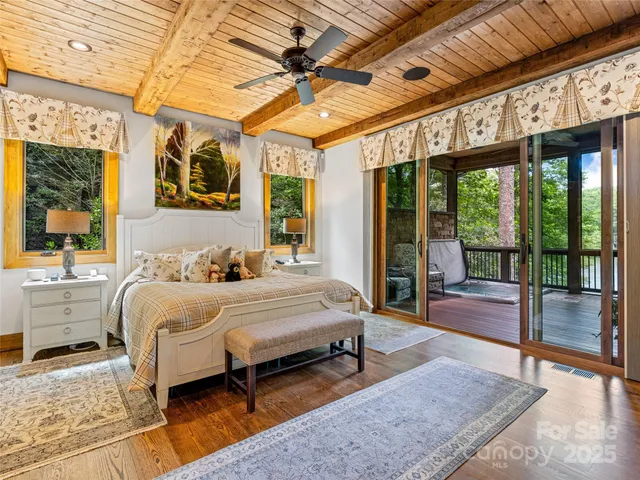a view of a patio with couches chairs potted plants and wooden floor