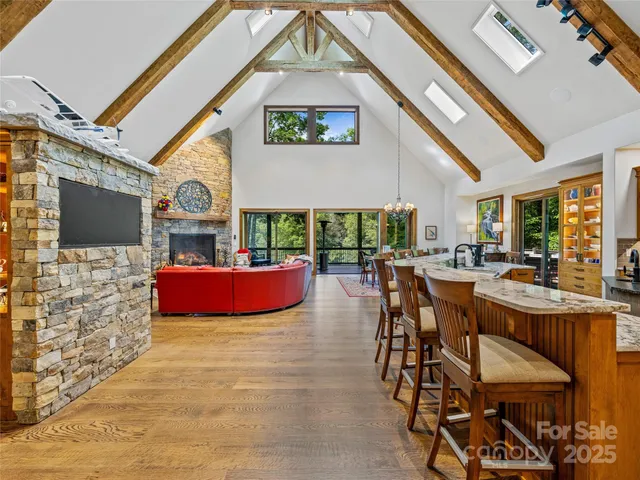 a living room with furniture a fireplace and a large window