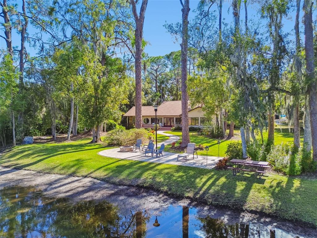 8011 North Mobley Road Odessa, FL 33556 - Photo 2 of 86 a view of a park with large trees and plants
