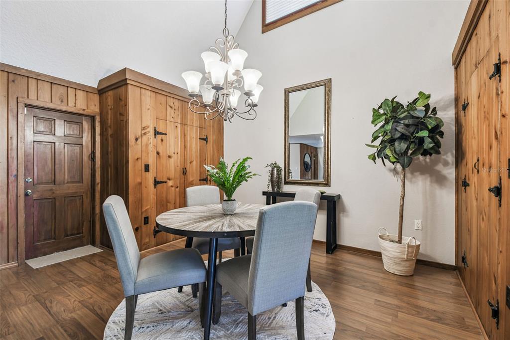 8011 North Mobley Road Odessa, FL 33556 - Photo 23 of 86 a view of a dining room with furniture and wooden floor