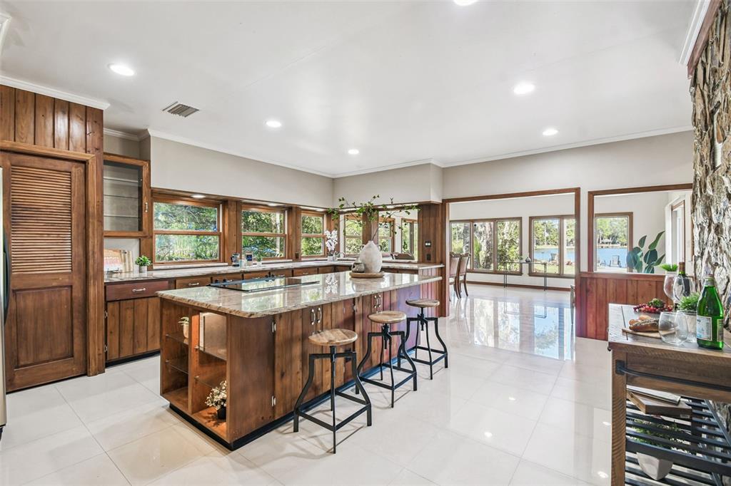 8011 North Mobley Road Odessa, FL 33556 - Photo 28 of 86 a dining hall with stainless steel appliances granite countertop a stove and a refrigerator
