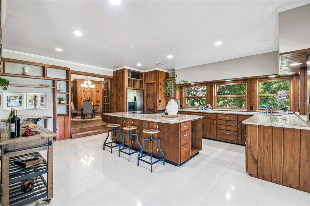8011 North Mobley Road Odessa, FL 33556 - Photo 29 of 86 a kitchen with stainless steel appliances granite countertop a stove and a refrigerator