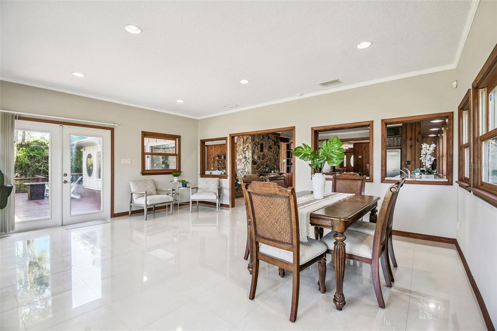 8011 North Mobley Road Odessa, FL 33556 - Photo 34 of 86 a dining room with furniture and a floor to ceiling window