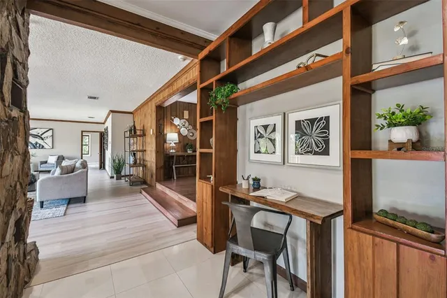 an aerial view of residential houses with outdoor space and trees