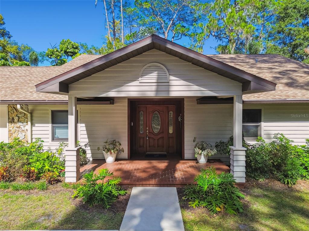 8011 North Mobley Road Odessa, FL 33556 - Photo 75 of 86 a front view of a house with garden