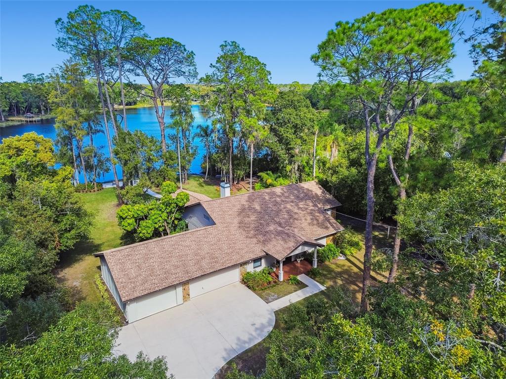 8011 North Mobley Road Odessa, FL 33556 - Photo 79 of 86 an aerial view of a house with garden space and street view
