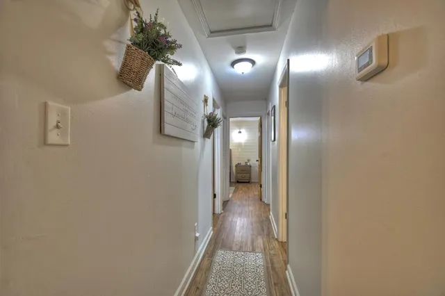 a view of hallway with chandelier and a mirror