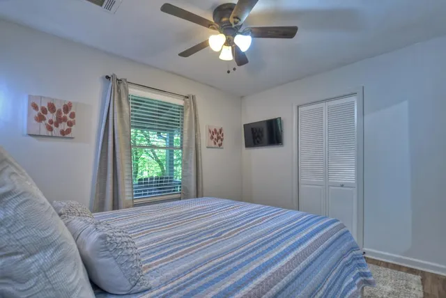 a bedroom with a bed and a chandelier