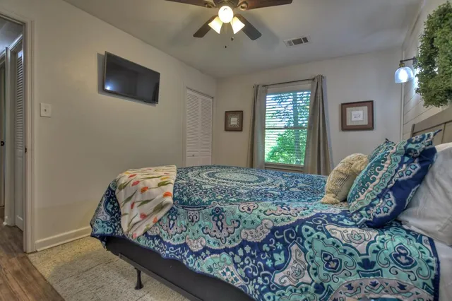 a bedroom with a bed and a flat screen tv