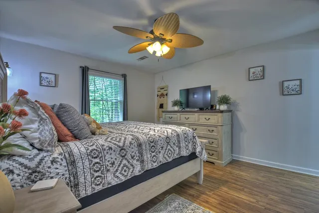 a bedroom with a bed and a flat screen tv