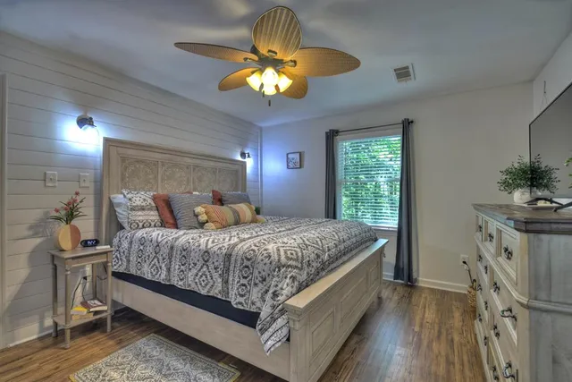 a bedroom with a bed and a chandelier