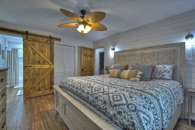 a bedroom with a bed and a chandelier