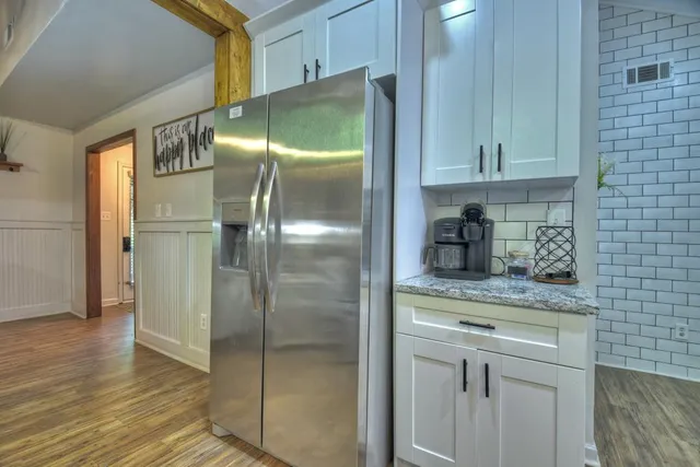 a kitchen with stainless steel appliances granite countertop a refrigerator and a stove