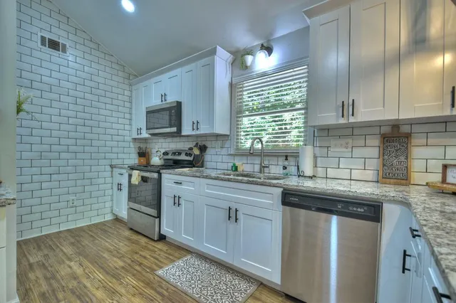 a kitchen with a sink cabinets and window