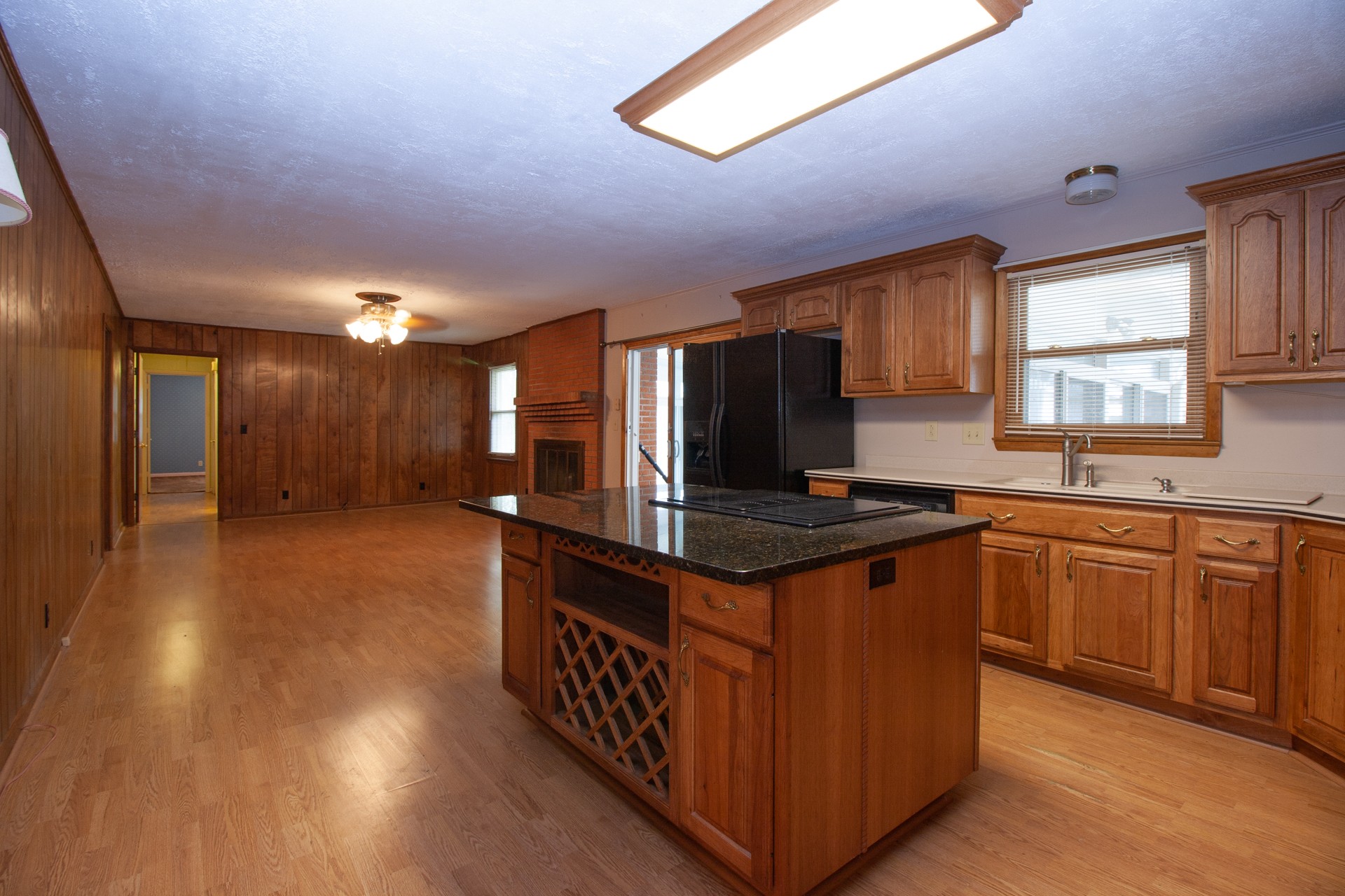 1431 Harrison Road Murfreesboro, TN 37128 - Photo 8 of 17 a kitchen with stainless steel appliances granite countertop a stove a sink dishwasher and a refrigerator with wooden floor