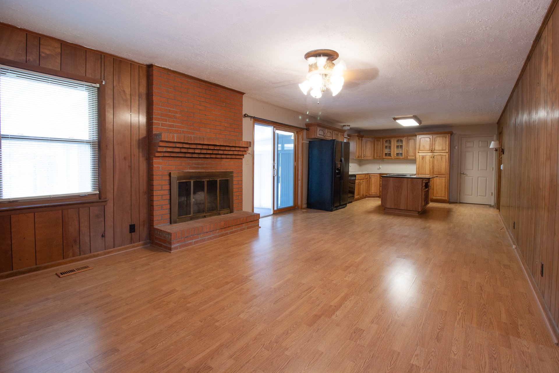 1431 Harrison Road Murfreesboro, TN 37128 - Photo 10 of 17 an empty room with wooden floor fireplace and windows