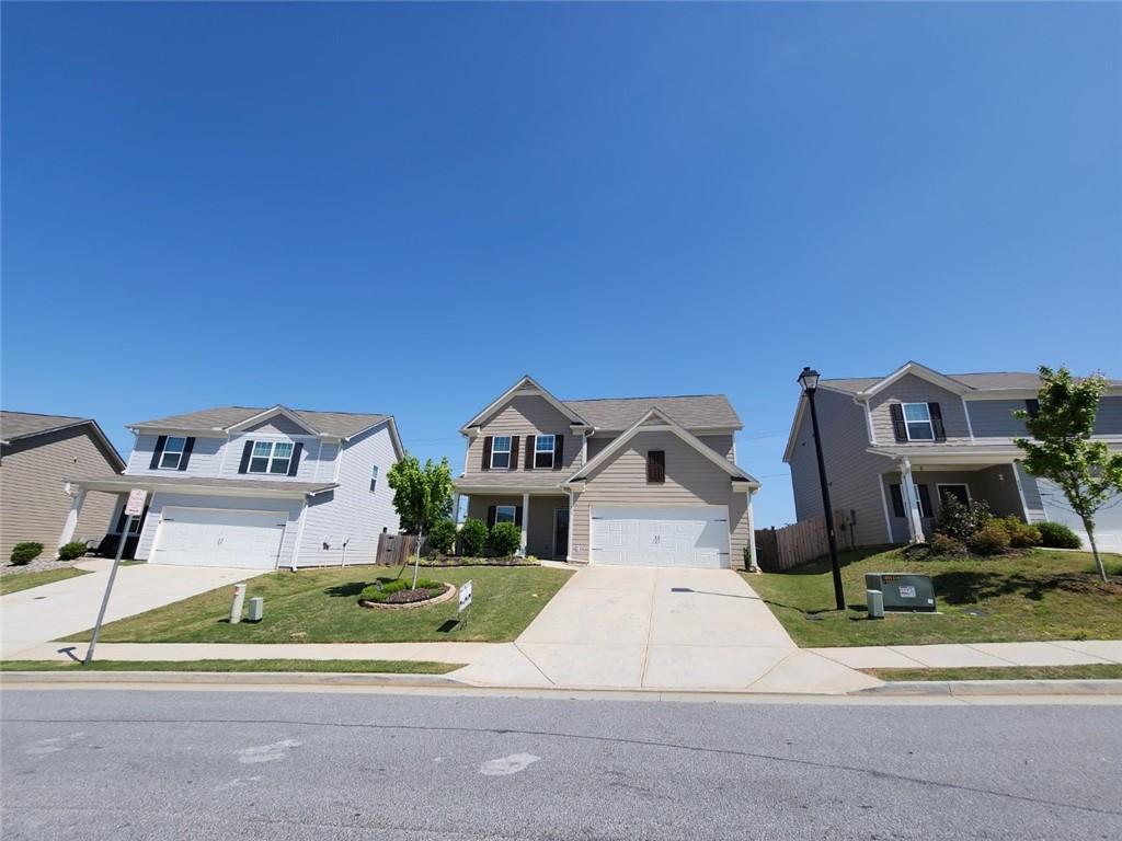 412 Merigold Way Pendergrass, GA 30567 - Photo 1 of 1 a front view of a house with a yard and garage