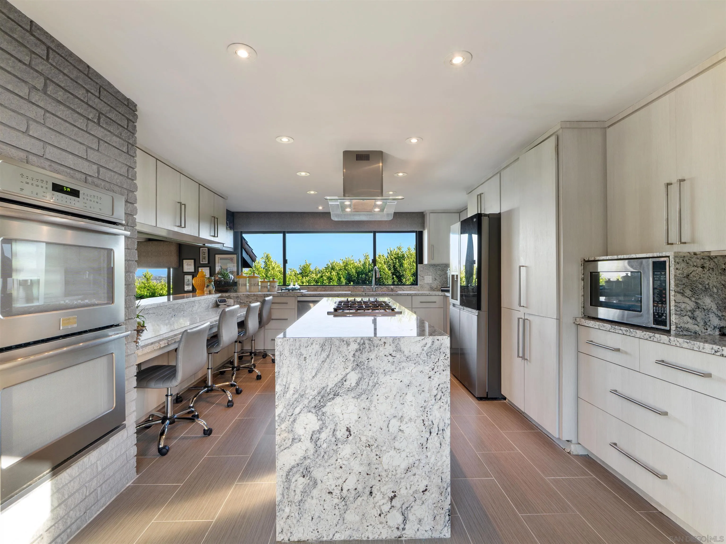 6315 Ridge Manor Avenue San Diego, CA 92120 - Photo 9 of 45 a kitchen with stainless steel appliances kitchen island granite countertop a refrigerator and a stove