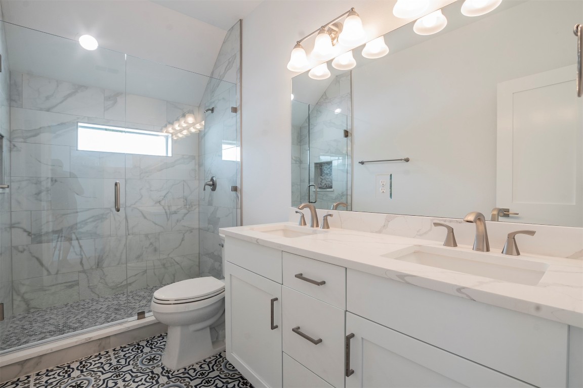 616 West Dittmar Road Austin, TX 78745 - Photo 16 of 37 a bathroom with a sink a toilet and shower