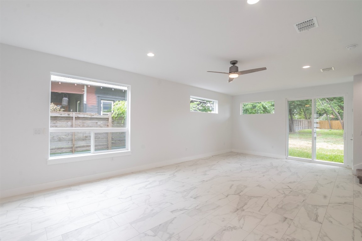 616 West Dittmar Road Austin, TX 78745 - Photo 30 of 37 an empty room with windows and ceiling fan