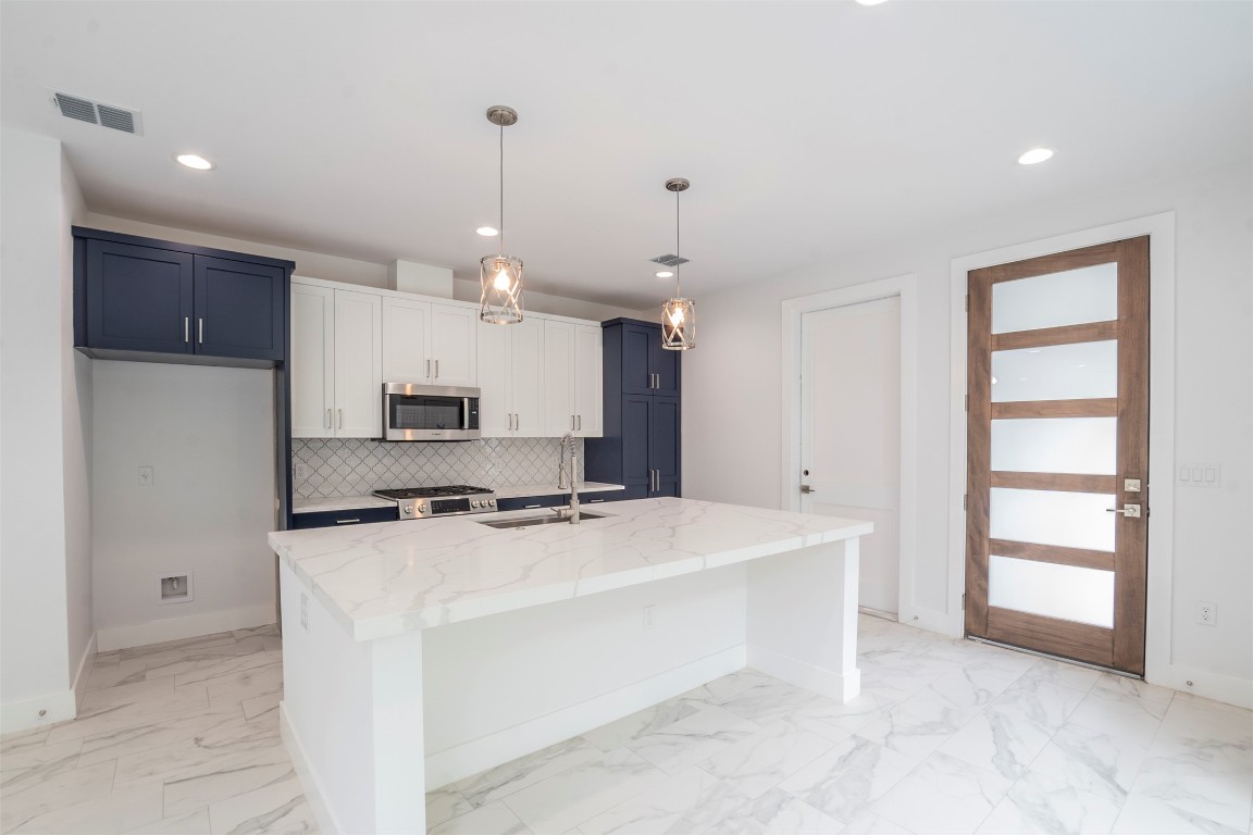 616 West Dittmar Road Austin, TX 78745 - Photo 36 of 37 a kitchen with a stove a sink and a refrigerator