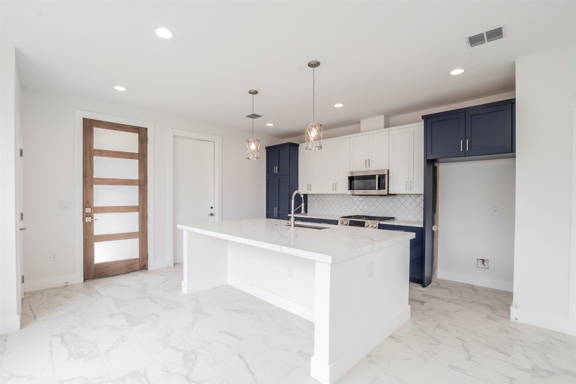 616 West Dittmar Road Austin, TX 78745 - Photo 9 of 37 a kitchen with stainless steel appliances a refrigerator sink and cabinets