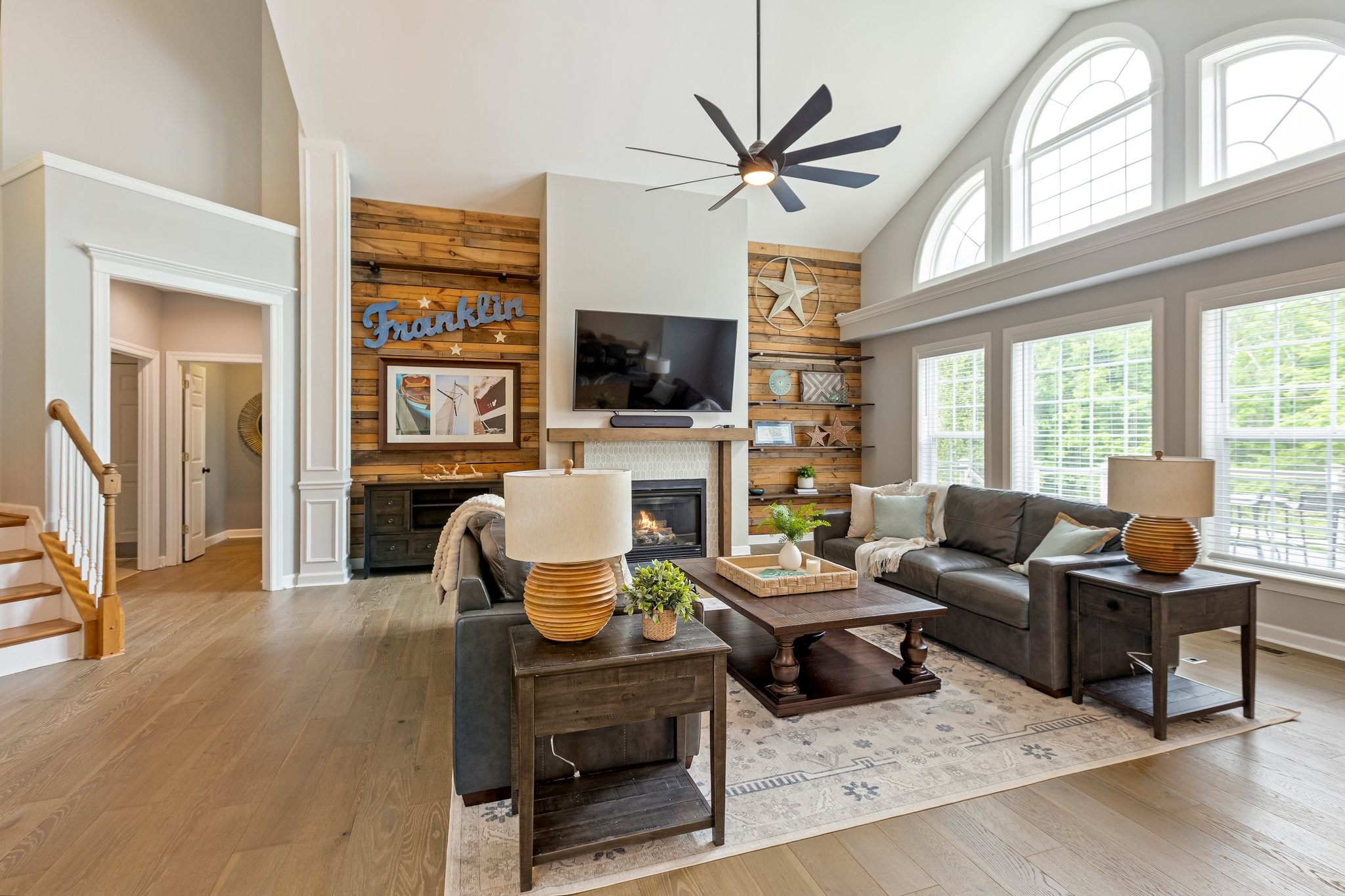 5048 Abington Ridge Lane Franklin, TN 37067 - Photo 16 of 64 a living room with furniture a flat screen tv and a large window