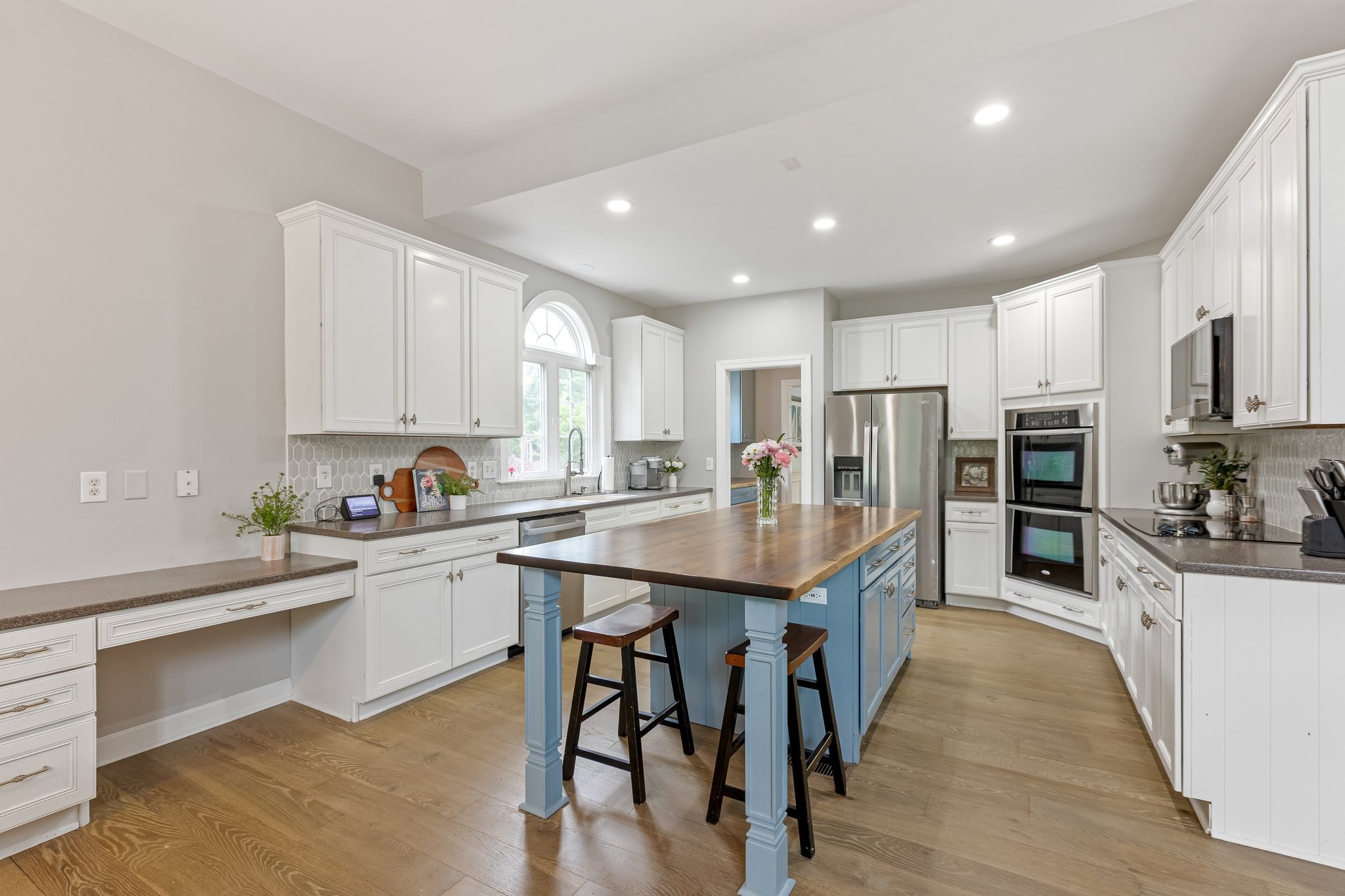 5048 Abington Ridge Lane Franklin, TN 37067 - Photo 22 of 64 a kitchen with stainless steel appliances granite countertop a table chairs sink refrigerator and cabinets