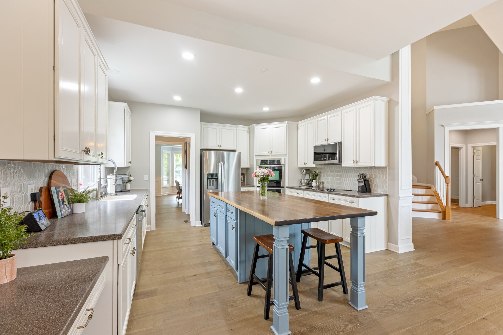 5048 Abington Ridge Lane Franklin, TN 37067 - Photo 24 of 64 a large kitchen with stainless steel appliances lots of counter space and breakfast area