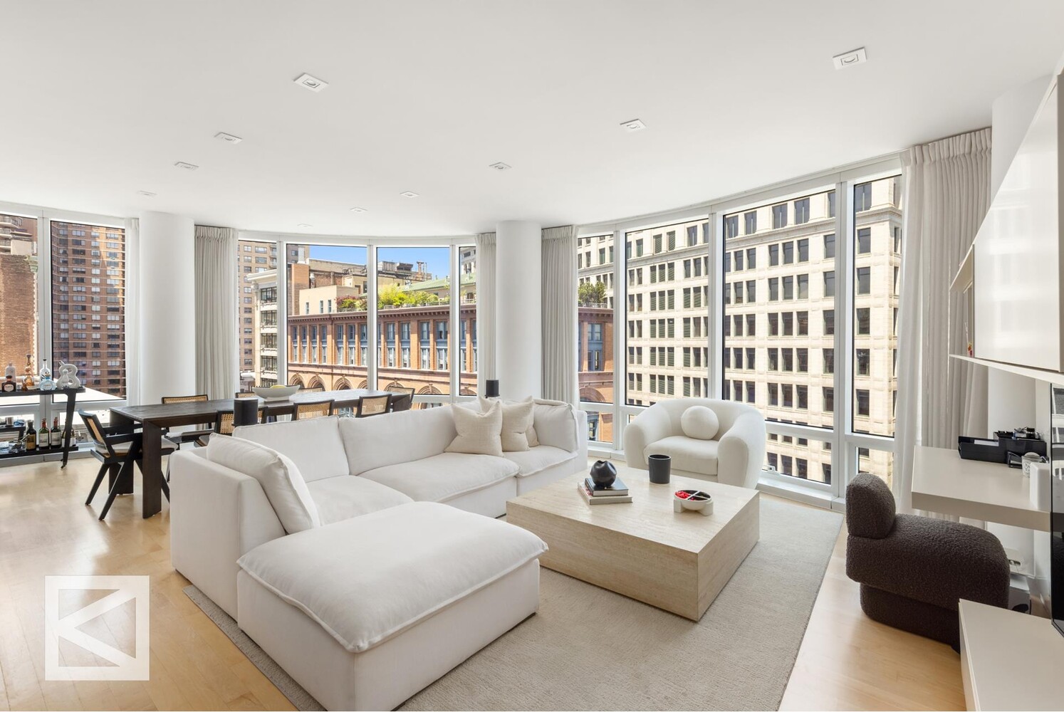 a living room with furniture and large windows