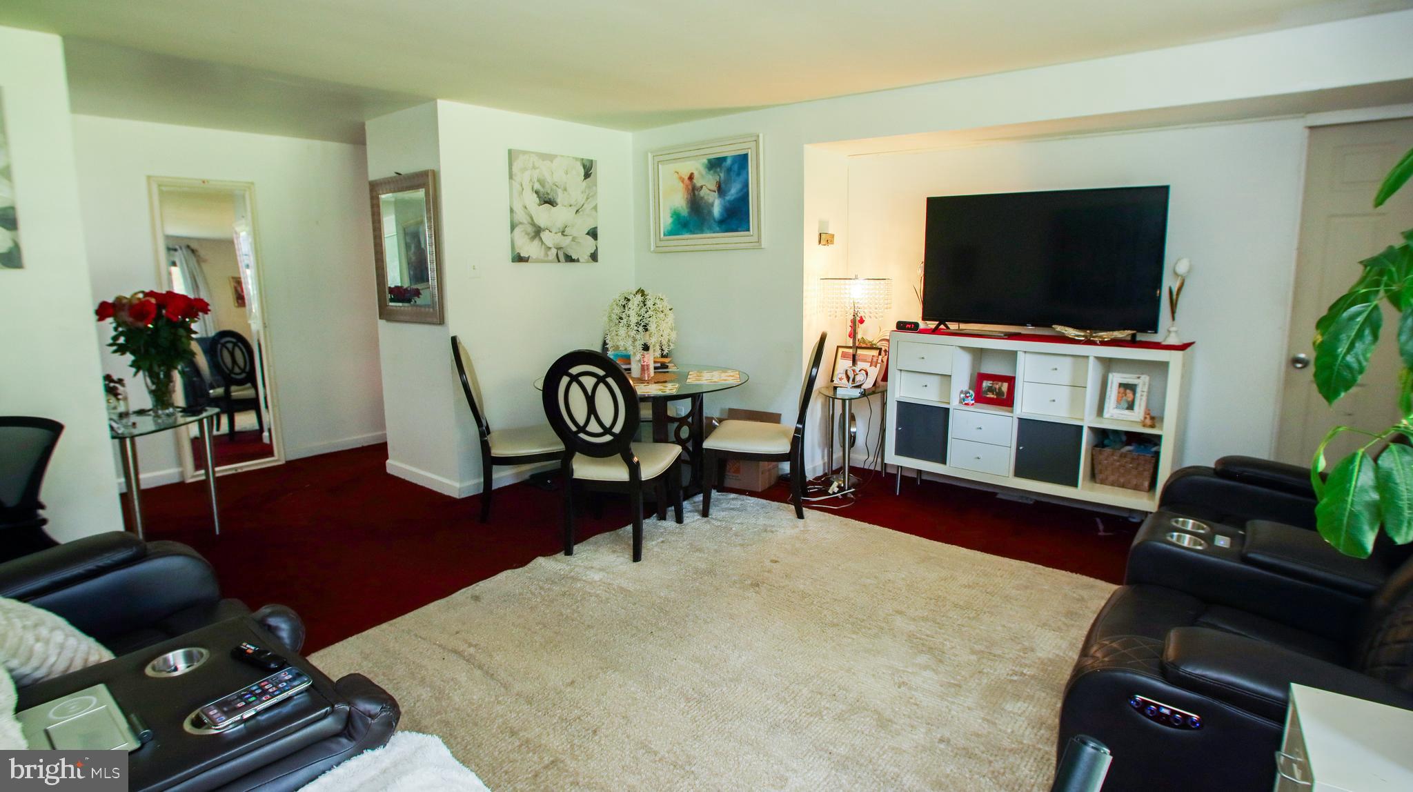 18925 Mills Choice Road, Unit 18925 Gaithersburg, MD 20886 - Photo 4 of 12 a living room with furniture and a flat screen tv