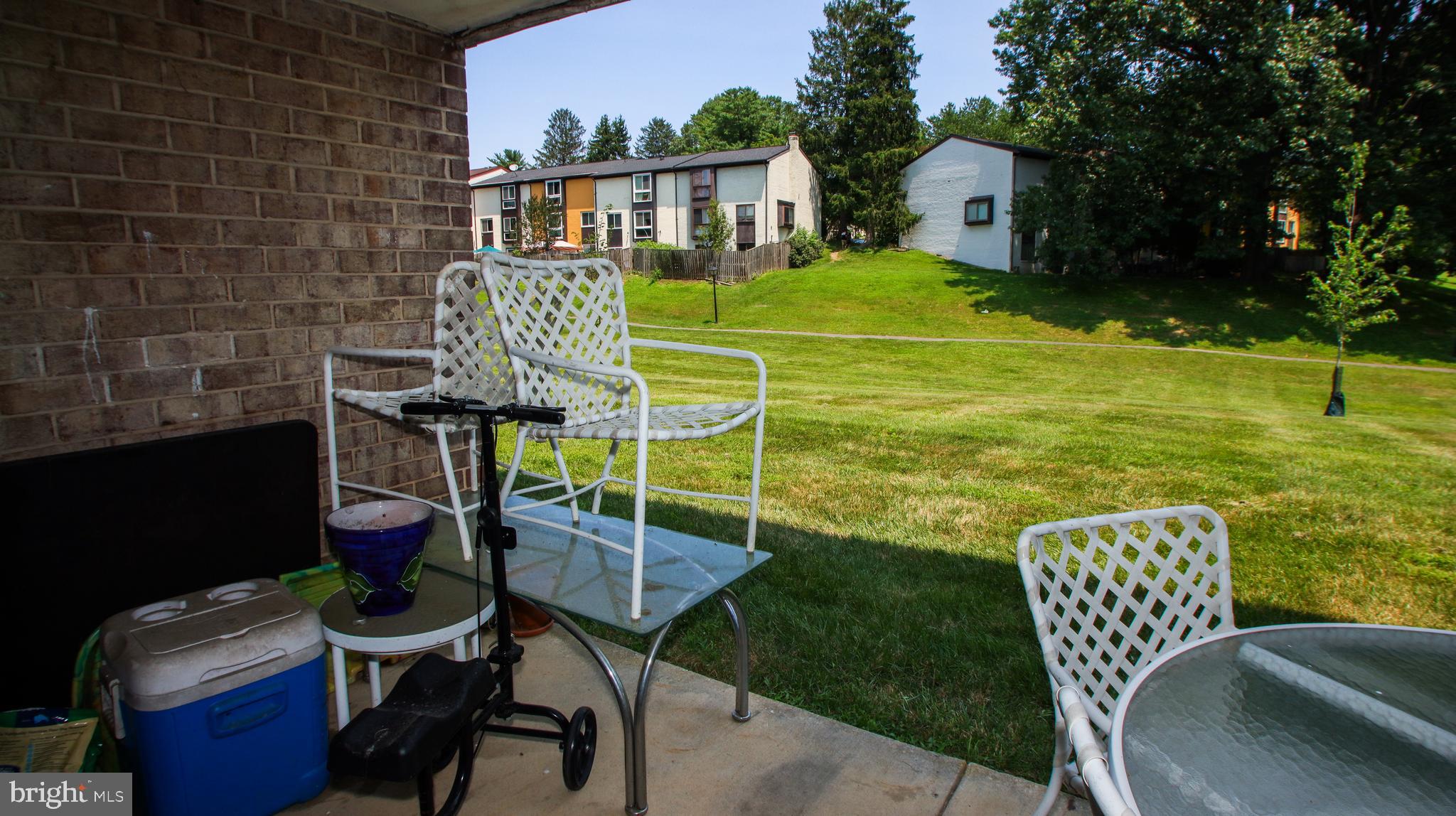 18925 Mills Choice Road, Unit 18925 Gaithersburg, MD 20886 - Photo 6 of 12 a view of a chairs and table in backyard