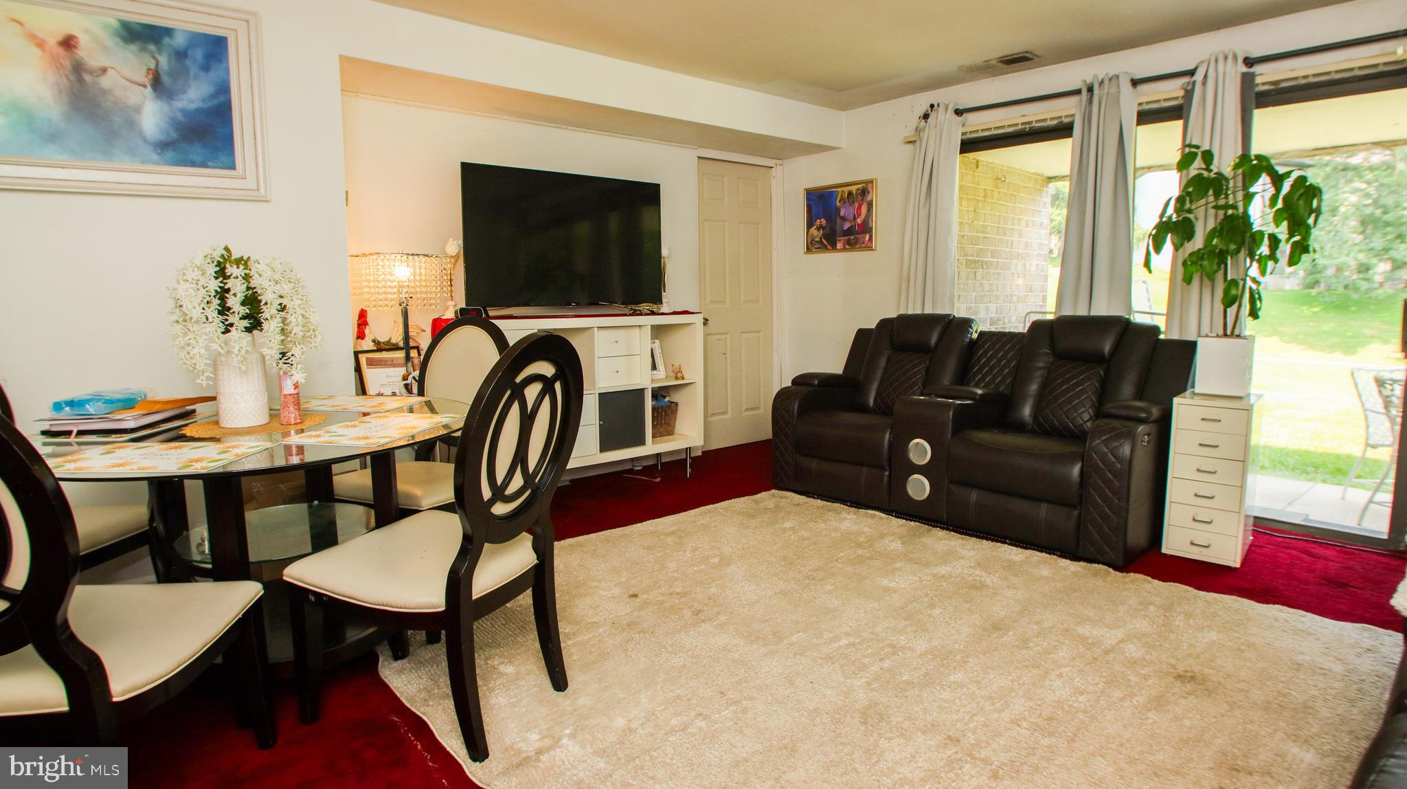 18925 Mills Choice Road, Unit 18925 Gaithersburg, MD 20886 - Photo 10 of 12 a living room with furniture and a flat screen tv