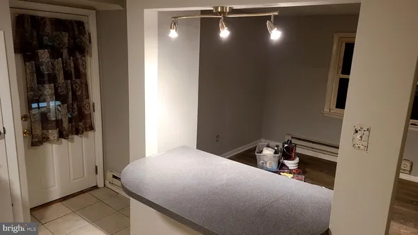 a view of a room with wooden floor and cabinet