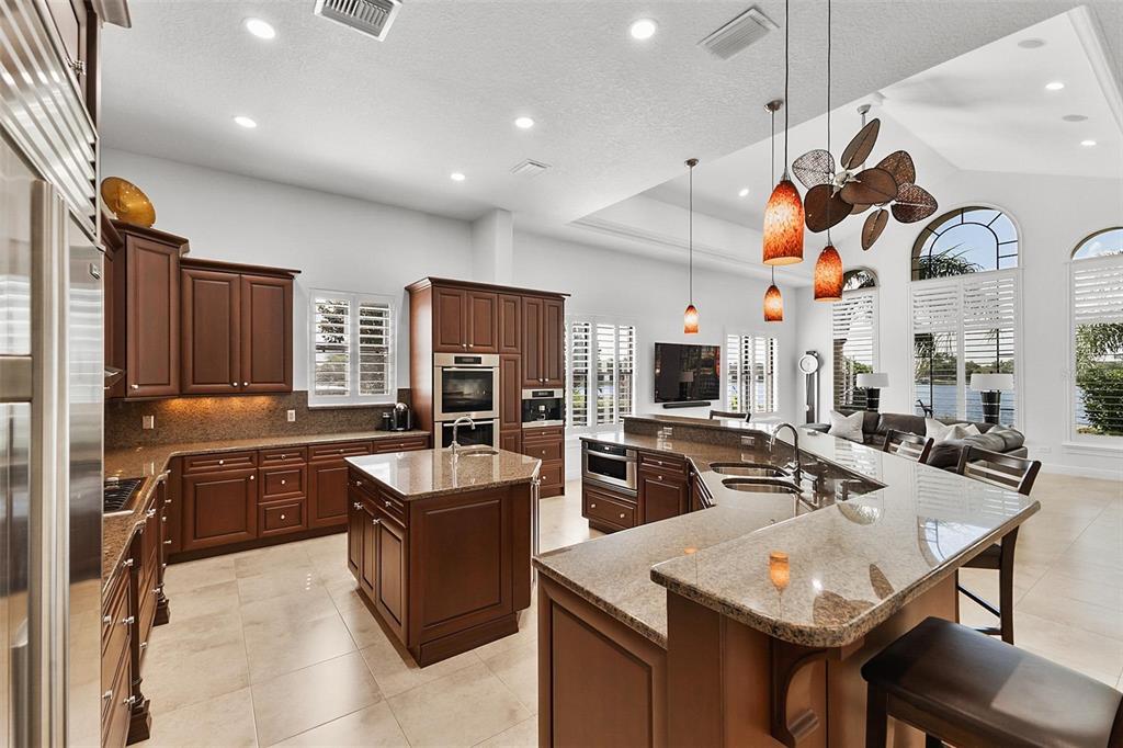 12812 Jacob Grace Court Windermere, FL 34786 - Photo 18 of 91 a kitchen with stainless steel appliances granite countertop a sink a stove and a refrigerator