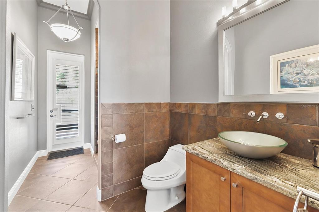 12812 Jacob Grace Court Windermere, FL 34786 - Photo 65 of 91 a bathroom with a granite countertop toilet and a sink