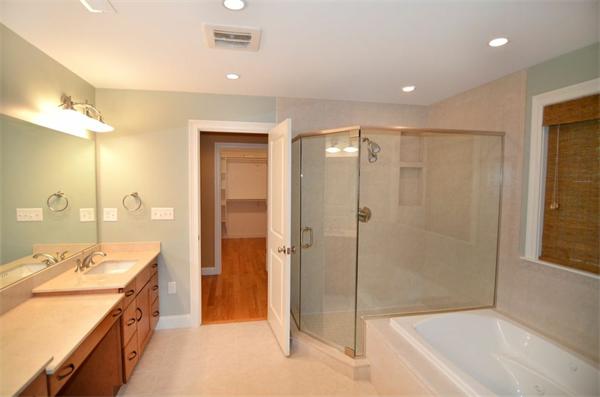 8 Douglas Road Lexington, MA 02420 - Photo 23 of 25 a spacious bathroom with a shower tub mirror and a sink