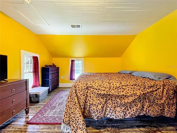 a bedroom with a bed and a rug