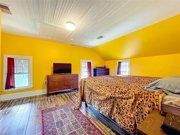 a bed room with a bed and a rug