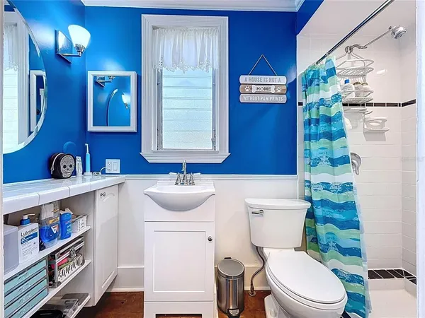 a bathroom with a tub sink and mirror