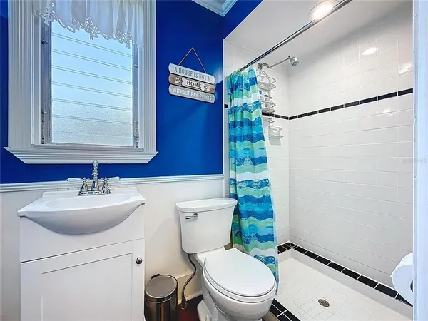 a bathroom with a toilet a sink and bathtub