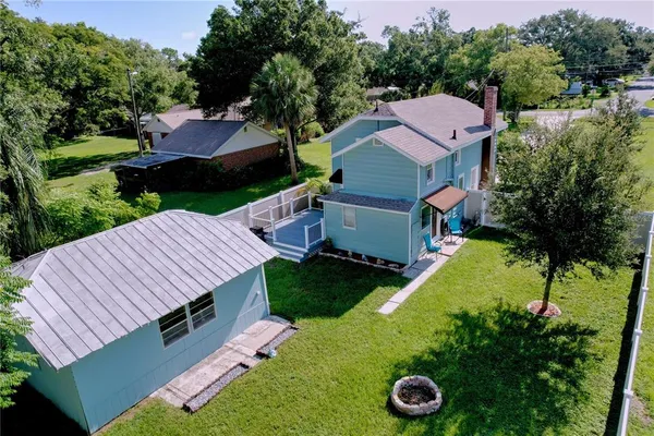 an aerial view of a house with outdoor space and street view