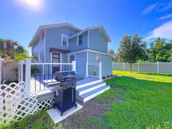 a view of a house with a yard porch and sitting area