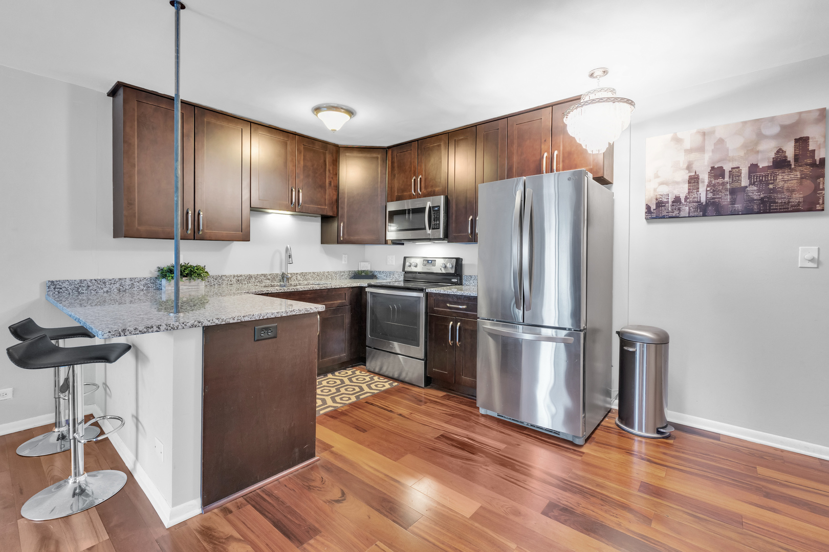 320 Circle Avenue, Unit 404 Forest Park, IL 60130 - Photo 3 of 16 a kitchen with granite countertop stainless steel appliances and wooden cabinets