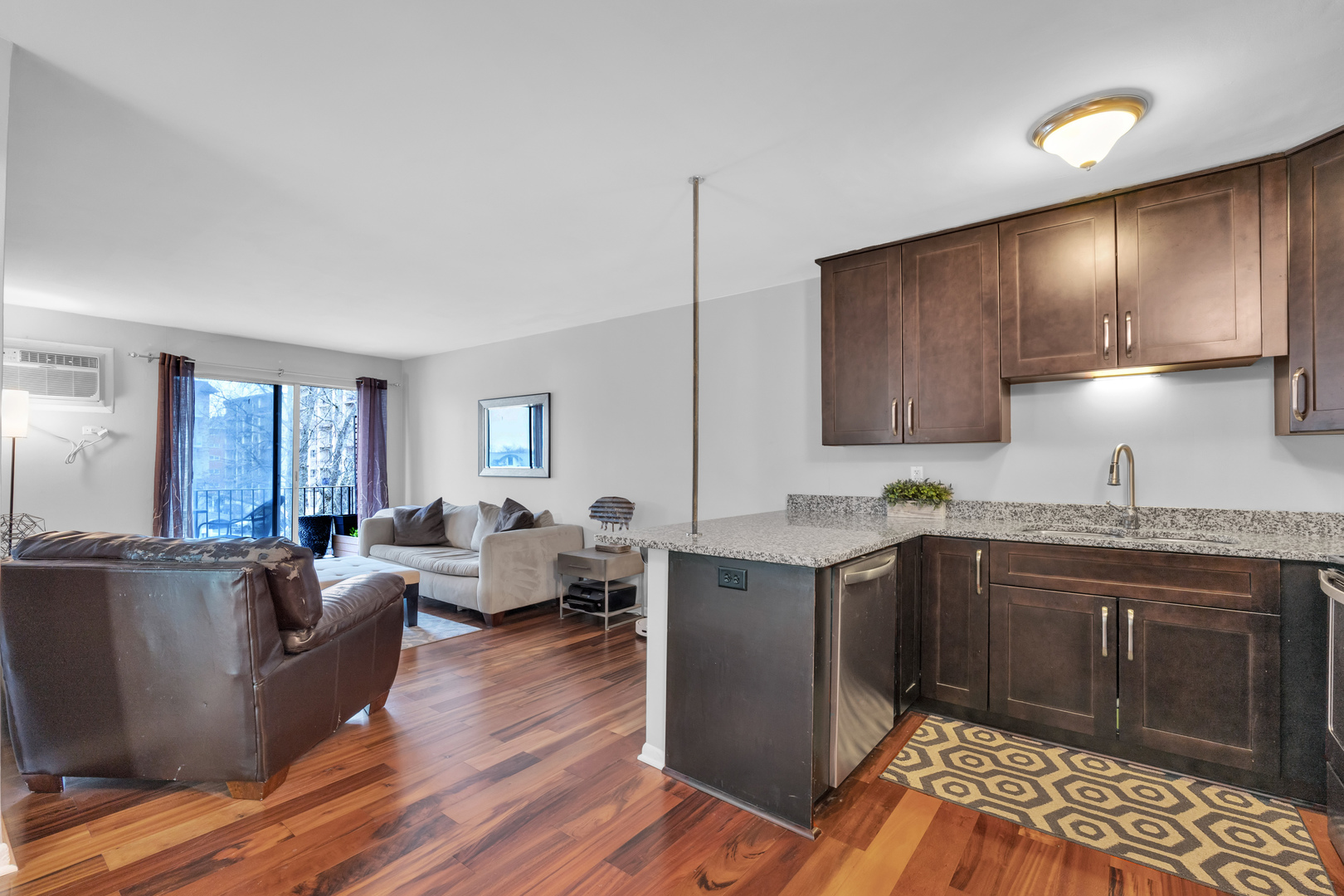320 Circle Avenue, Unit 404 Forest Park, IL 60130 - Photo 4 of 16 a living room with stainless steel appliances granite countertop furniture wooden floor and a view of kitchen