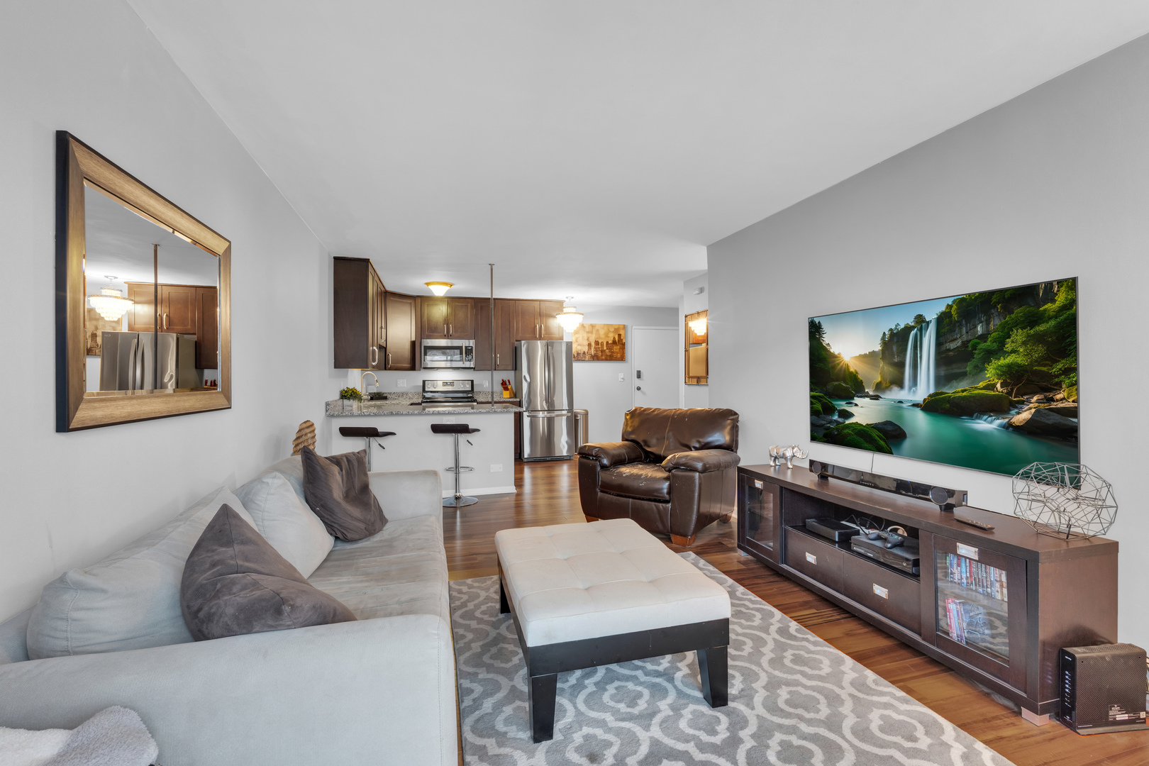 320 Circle Avenue, Unit 404 Forest Park, IL 60130 - Photo 7 of 16 a living room with furniture and a flat screen tv