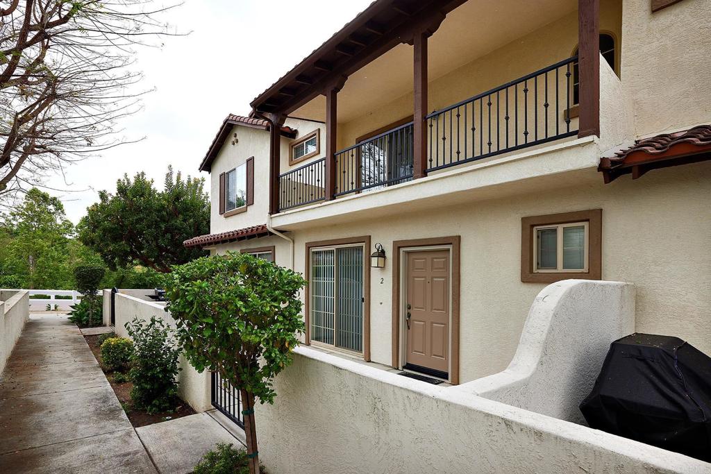 a view of a house with couches and potted plants