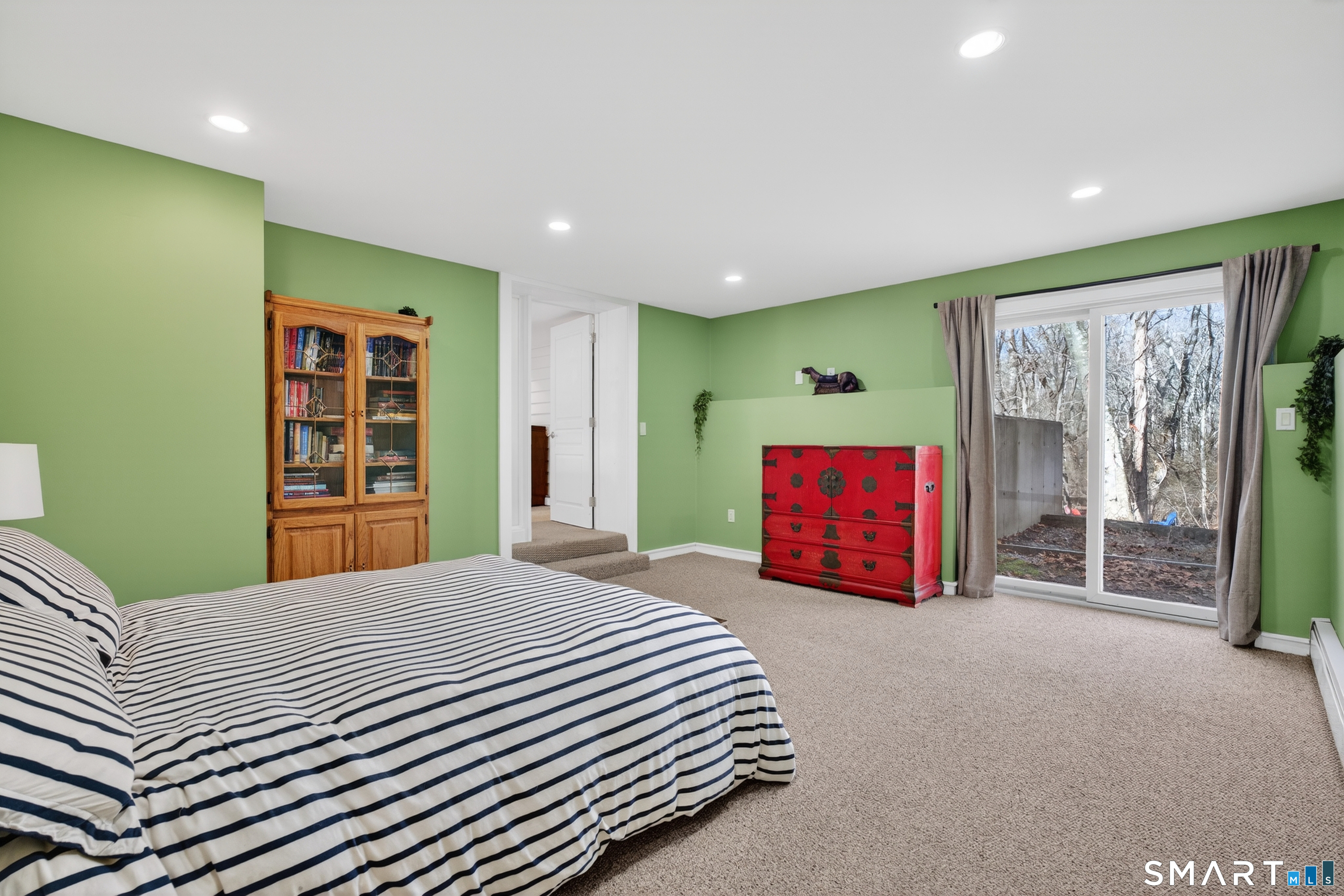 18 Riverside Terrace Madison, CT 06443 - Photo 29 of 40 a bedroom with a large bed and a chandelier